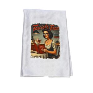 Kitchen towel featuring a retro-style illustration of a woman reading a recipe book with a bold feminist message