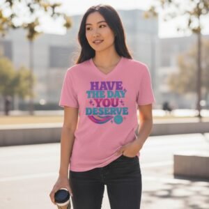 Graphic t-shirt featuring the phrase “Have the Day You Deserve” with playful decorative elements.