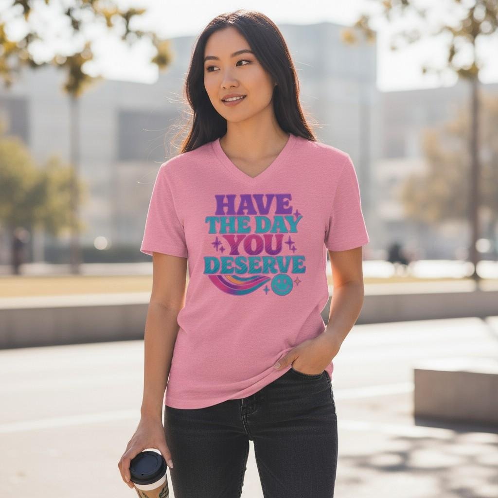 Have The Day You Deserve (1) Graphic t-shirt featuring the phrase “Have the Day You Deserve” with playful decorative elements.