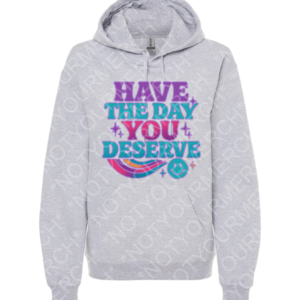 Unisex pullover hoodie featuring the phrase “Have the Day You Deserve” in playful lettering with decorative accents.