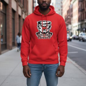 Unisex pullover hoodie featuring a bold political satire graphic with the text “Village Idiot.”