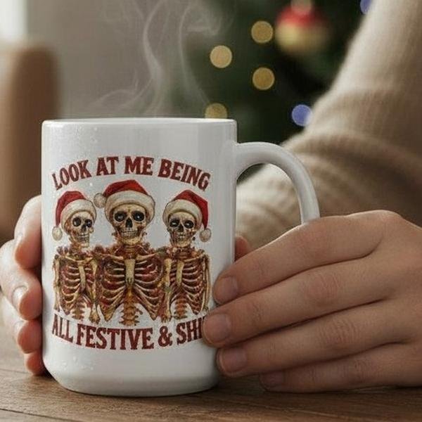 FestiveSkeltonsMug 15oz ceramic mug with festive skeleton design and “Look at Me Being All Festive & Shit” text