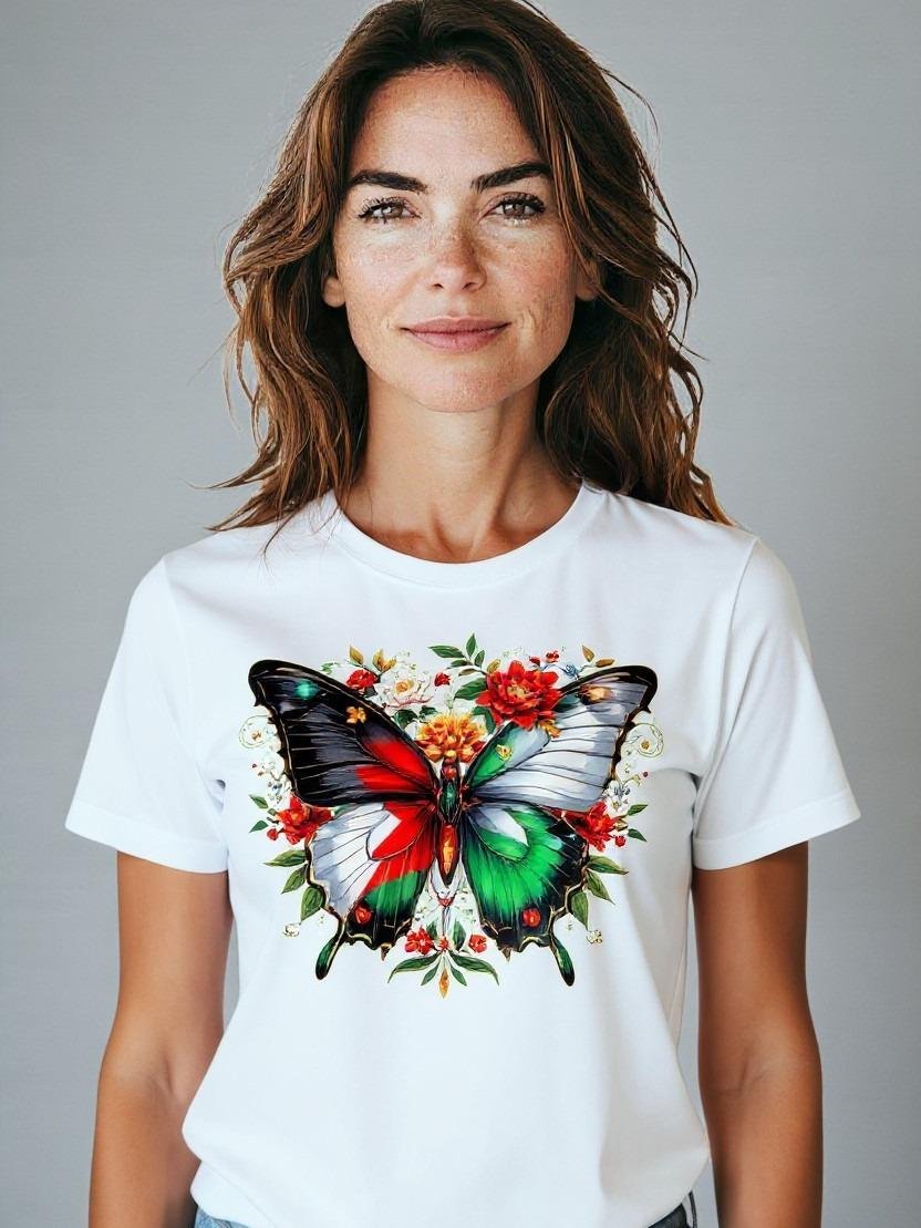 PalestineButterfly Model wearing a graphic t-shirt featuring a Palestinian butterfly illustration surrounded by floral details.