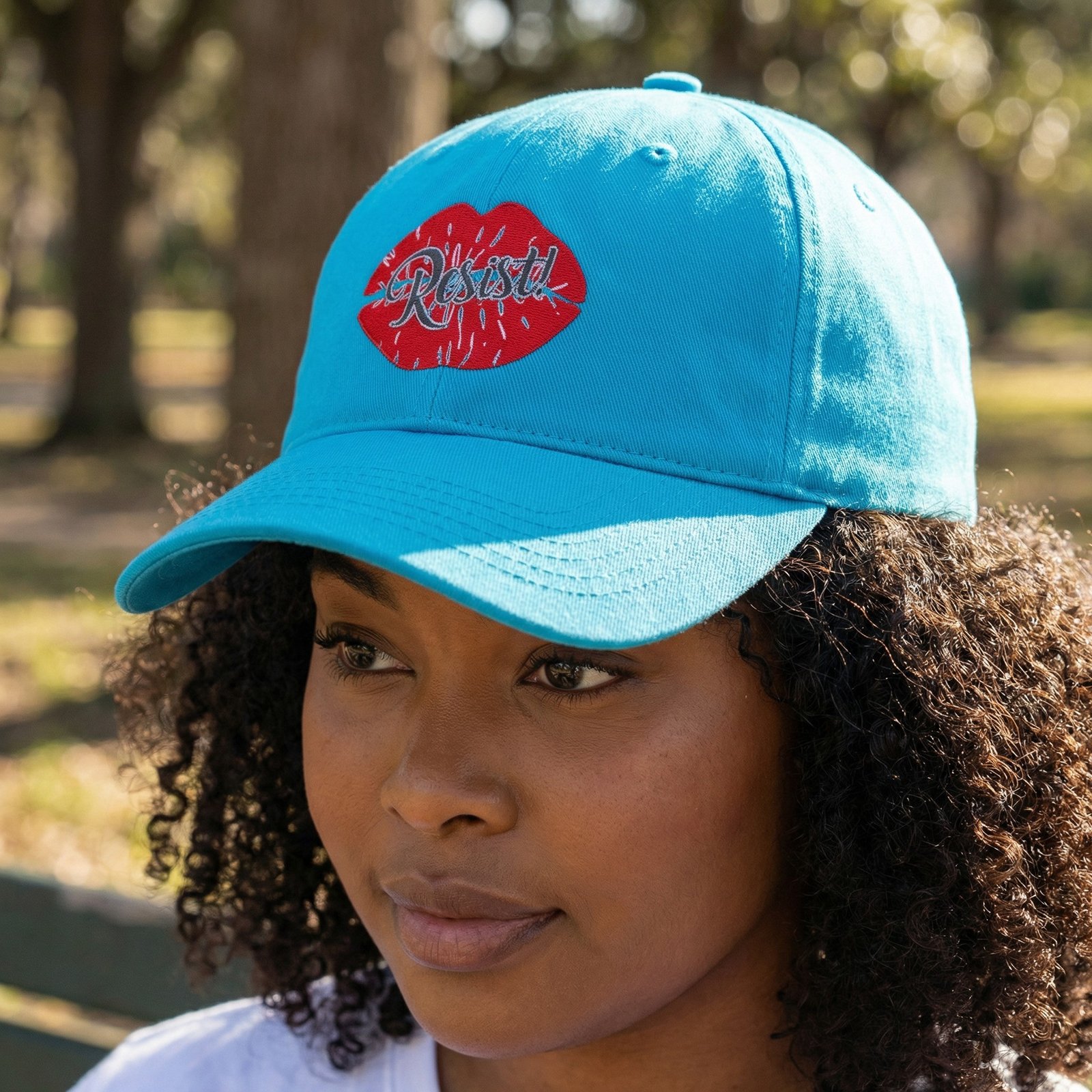 ResistLipHat Pink dad hat with red lips graphic and the word “Resist.”