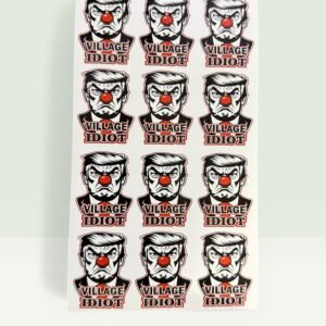 Sheet of “Village Idiot” vinyl stickers featuring a bold illustrated face and text design.