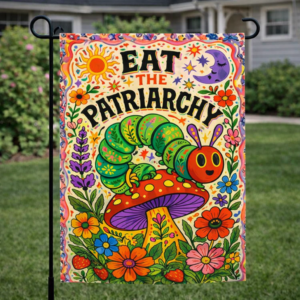 Sublimated feminist garden flag with caterpillar, mushroom, floral artwork, and Eat the Patriarchy text displayed outdoors.