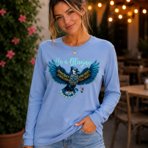 Woman wearing a long sleeve t-shirt with a bluejay graphic and inspirational typography design.