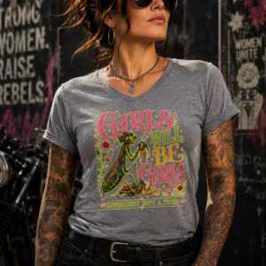 Graphic t-shirt featuring a detailed praying mantis illustration with “Girls Will Be Girls” typography and floral artwork.