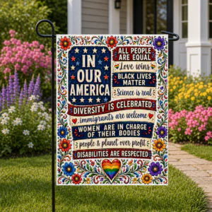 Sublimated inclusive patriotic garden flag with equality and unity messages displayed outdoors.