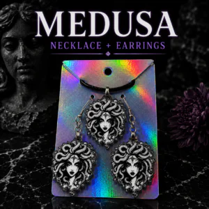 Medusa jewelry set featuring a matching necklace and earrings with detailed mythology-inspired artwork.