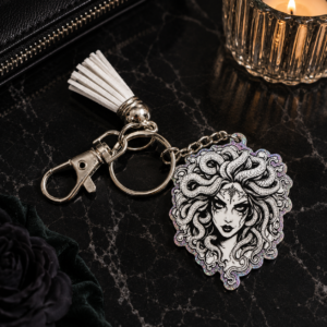 Medusa tassel keychain featuring detailed mythology-inspired artwork with decorative tassel and keyring attachment.