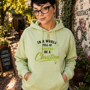 Graphic hoodie featuring the words "NYM Feminati Founding Member" with a decorative crown and laurel emblem.