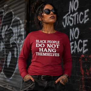 Woman wearing a red Black People Do Not Hang Themselves long sleeve shirt
