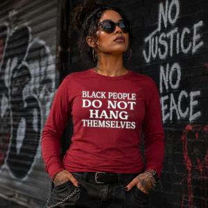 Woman wearing a red Black People Do Not Hang Themselves long sleeve shirt