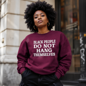 Woman wearing a burgundy Black People Do Not Hang Themselves crewneck sweatshirt